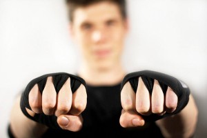 Burke wearing weight-lifting gloves with fists raised to camera